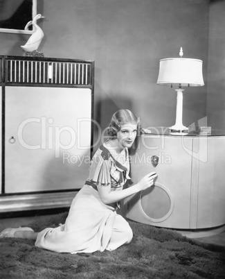 Woman sitting on the floor listening to her radio