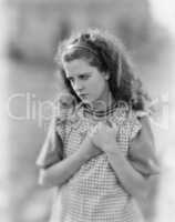 Young woman clenching her hands looking sad