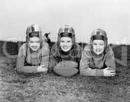 Portrait of three women in football helmets