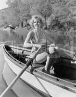 Woman in a striped bathing suit rowing