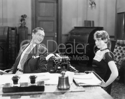 Man and woman in an office flirting with each other