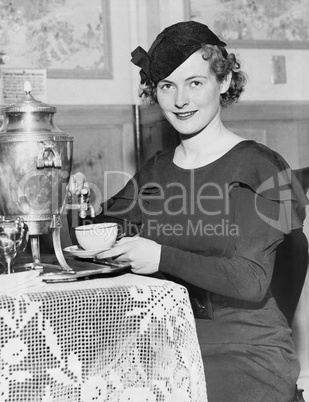 Woman pouring coffee from a coffee urn