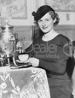 Woman pouring coffee from a coffee urn