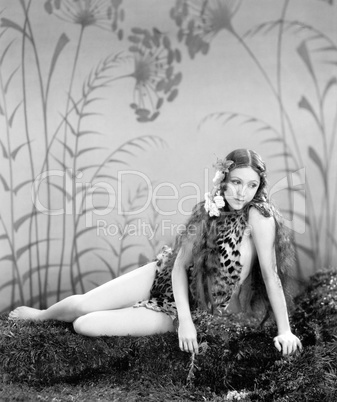 Woman in a Leopard skin sitting on the ground