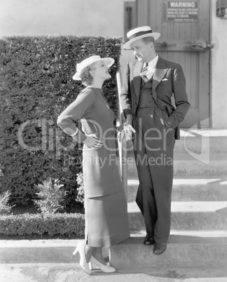 Elegant couple standing together and looking at each other