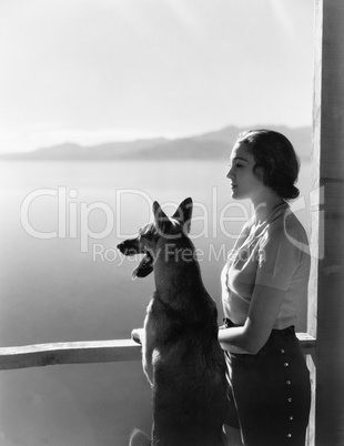 Woman and her German Shepherd overlooking a lake
