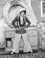 Woman in a sailors outfit in front of a life preserver