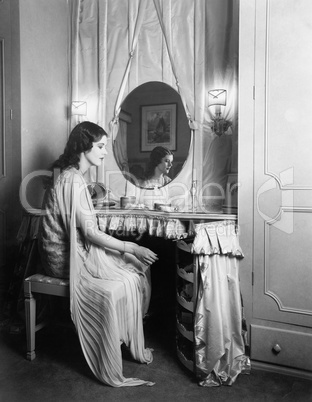 Woman sitting at her vanity table