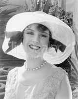 Woman in a wide brimmed hat smiling