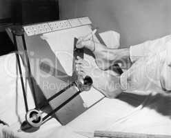 Feet of a disabled man using a drafting board