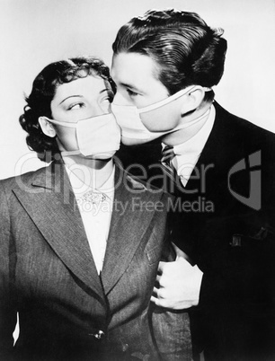 Couple kissing each other with health masks