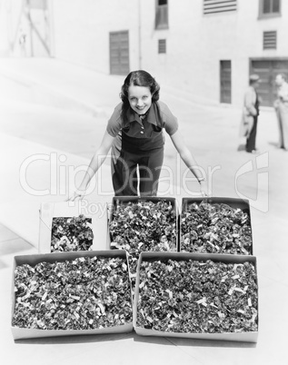 Young woman presenting poppies in a box