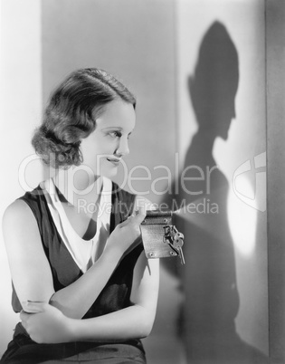 Young woman using a flashlight on her key chain