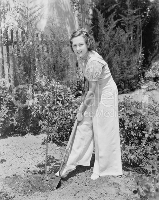Young woman doing gardening in her backyard