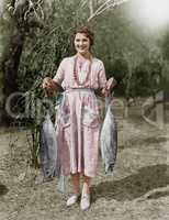 Young woman holding two huge fish