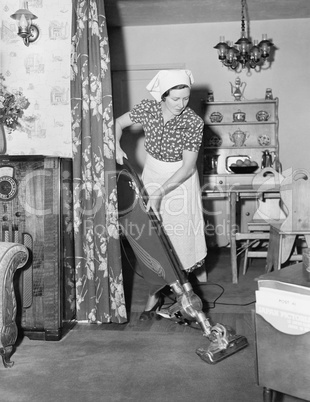 Woman doing housework with a vacuum cleaner