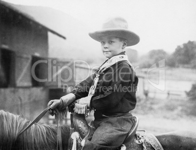Boy in a cowboy hat on a horse