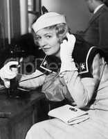 Young woman in a sailors uniform on the telephone
