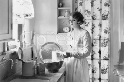 Young woman in her kitchen, baking