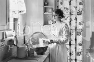 Young woman in her kitchen, baking