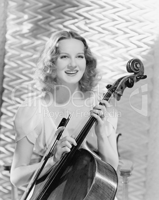 Young woman holding a bow and cello