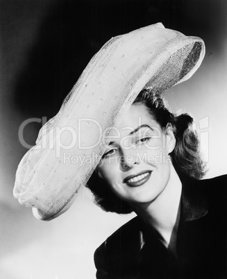 Young woman with a big white hat