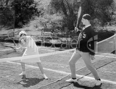 Couple playing tennis together