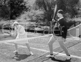 Couple playing tennis together