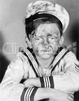 Boy in his sailors outfit with dirty face