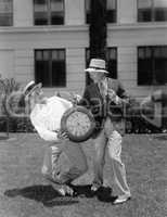 Two men wrestling with an oversized pocket watch
