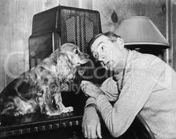 Man and dog listening to the radio