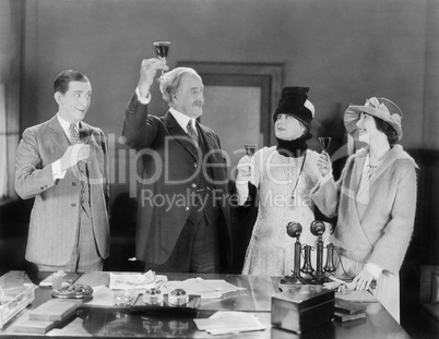 Four people toasting with wine