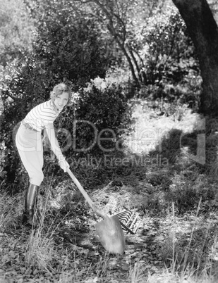 Young woman in a garden doing gardening