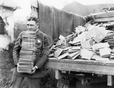 Man unloading a truck full of letters