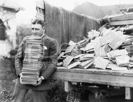 Man unloading a truck full of letters