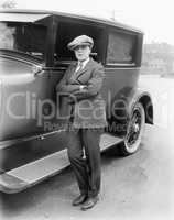 Young woman in men's clothing standing next to car