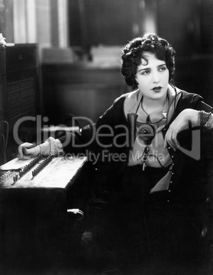 Young woman working as a telephone operator