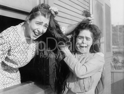 Two women fighting and pulling each others hair