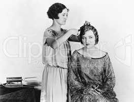One woman doing another woman's hair