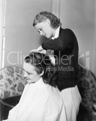 One woman doing an other woman's hair
