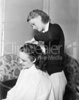 One woman doing an other woman's hair