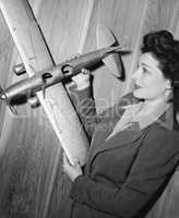 Young woman holding a model plane