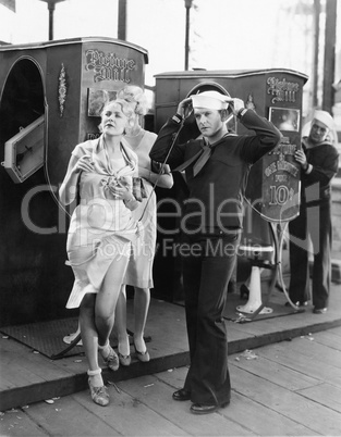 Sailor and a woman standing together on a boardwalk