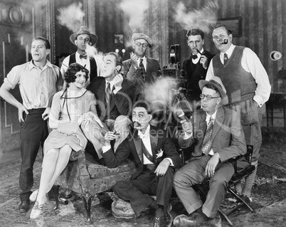 Group of people sitting in a living room smoking