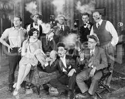 Group of people sitting in a living room smoking