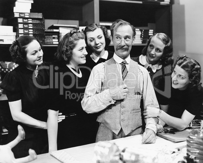 Five young women gathering around a salesman in a store