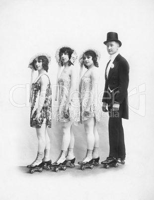 Four people on roller-skates standing in a line