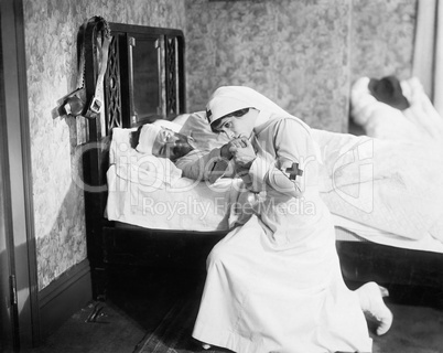 Nurse praying for an outlaw lying in bed