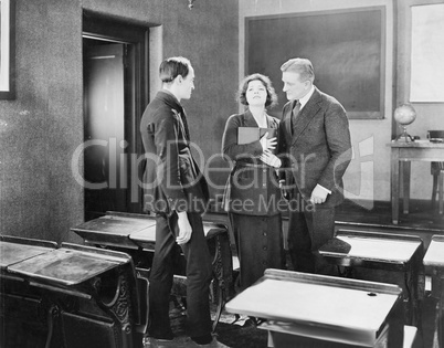 Young woman performing for two men in a class room