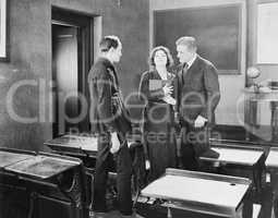 Young woman performing for two men in a class room
